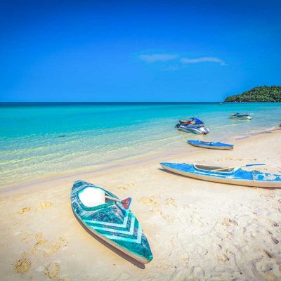Kayaks laying on a stunning white sandy beach in Phu Quoc