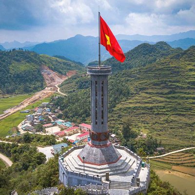 Close-up aerial view of Lung Cu Flag Tower – The Lung Cu Flag Tower, standing tall on Rong Mountain, symbolizing Vietnam’s northernmost point.