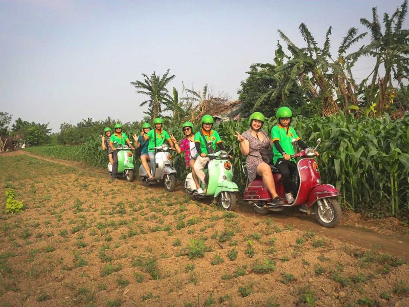 motorbike tour hanoi vespa 11 Travelers riding Vespa motorbikes through Hanoi’s countryside with local guides on a motorbike tour