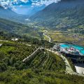 A view over Muong Hoa Valley in Sapa with on the for ground a resort with pool on the rooftop