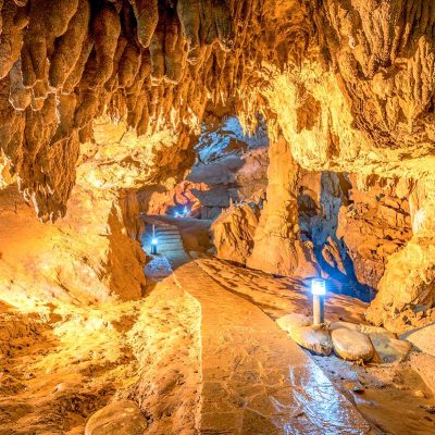 A path with lights going through the Nguom Ngao Cave