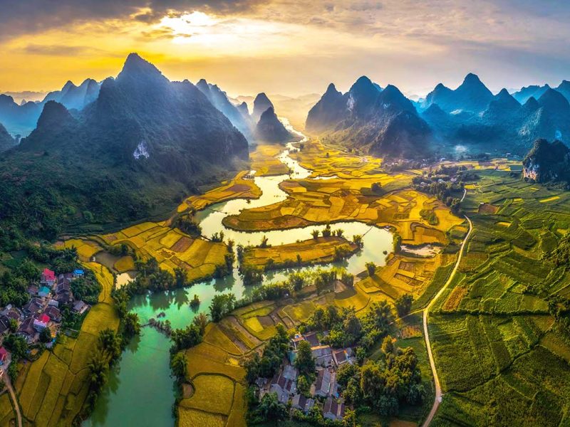 phong nam valley 1 Aerial view of Phong Nam Valley with a river running through a valley surrounded by rice fields and mountains.
