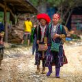 two ethnic Red Dao woman walking through the village of Ta Phin in Muong Hoa Valley near Sapa